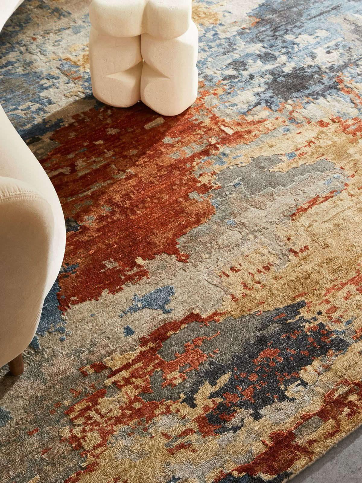 A hand-knotted rug styled in a furnished living room