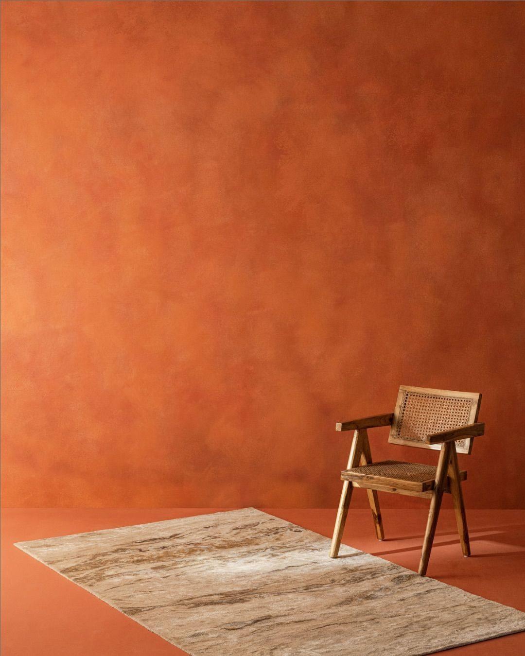 A hand-loomed flatweave rug styled in a furnished room