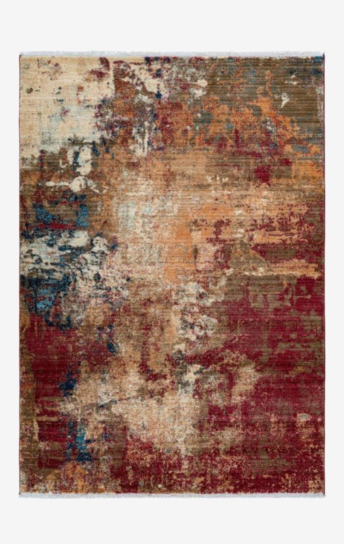 Stacked hand-loomed flatweave rugs in striped patterns