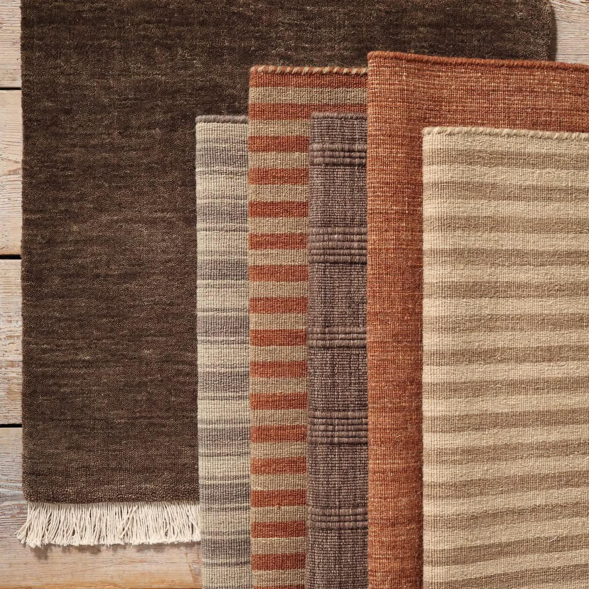 Artisan weaving on a floor loom with a shuttle