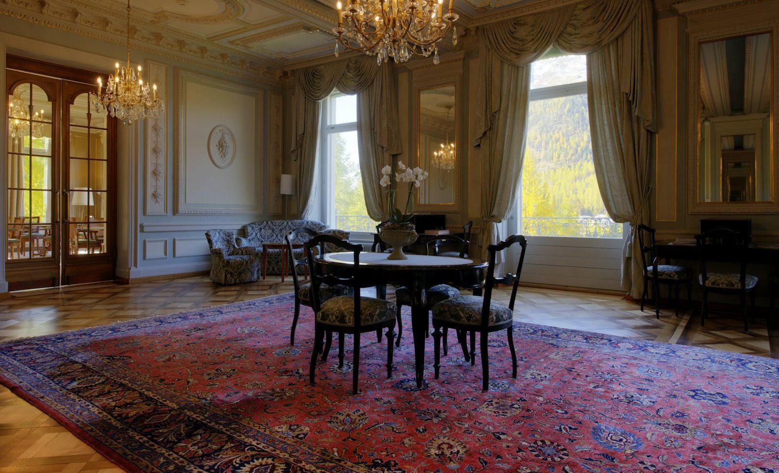 Hand-knotted Persian rug beneath a dining table in an opulent parlour