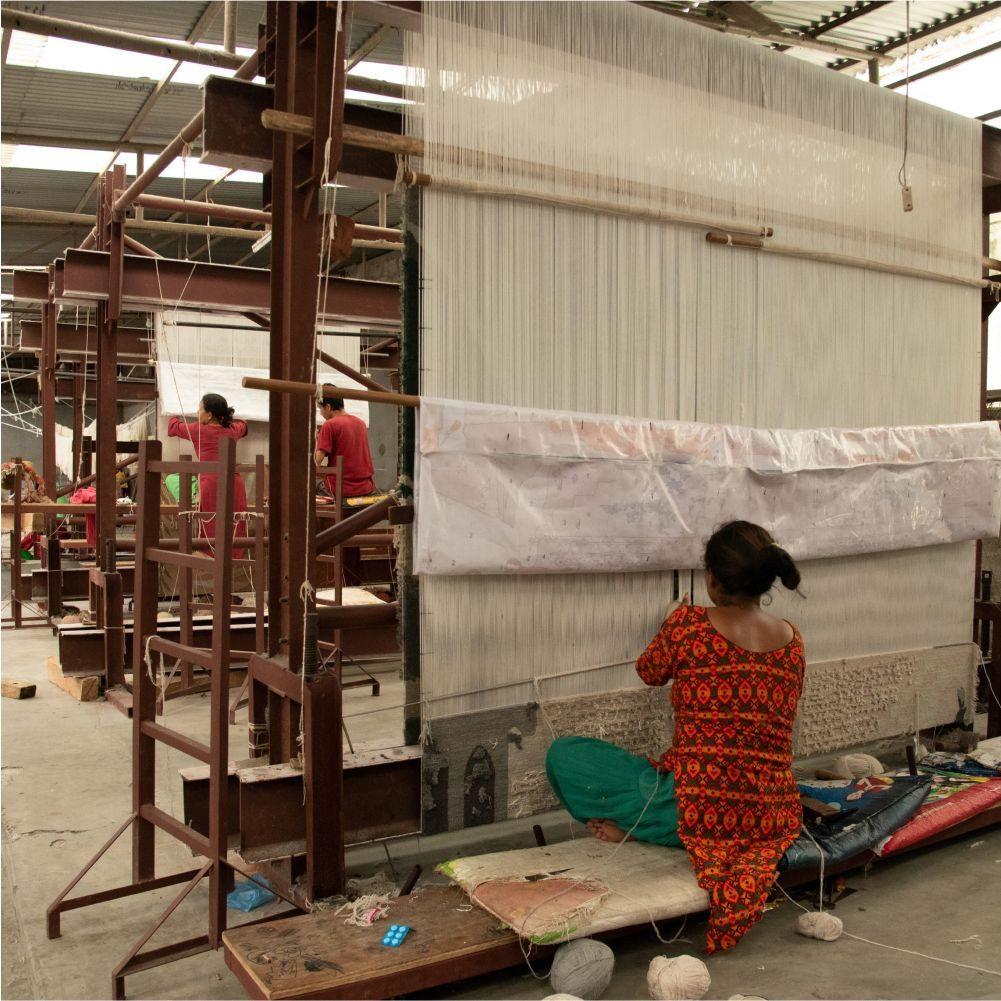Artisan working a handloom warp in the workshop